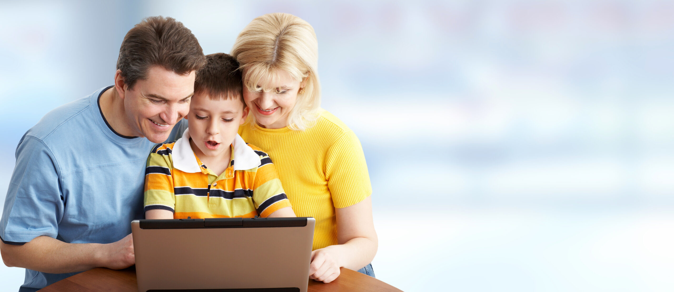 Family with laptop computer.