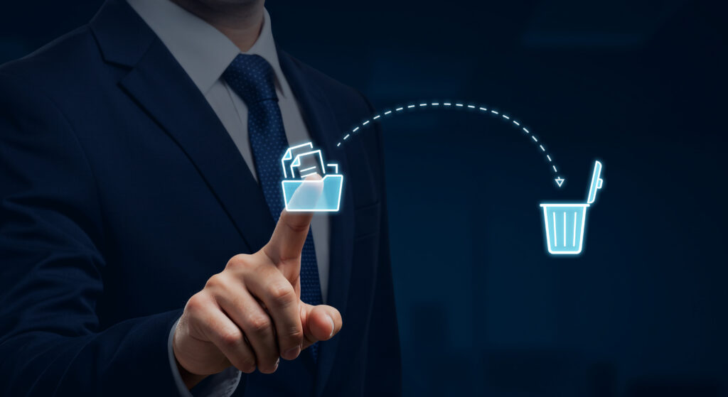 Businessman deleting files with a digital interface, represented by a Recycle Bin icon. A clean and efficient method for data management and file recycling.