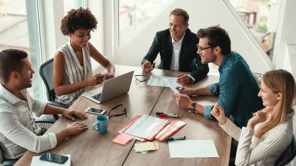 Employees working securely using best employee cybersecurity habits in a modern office